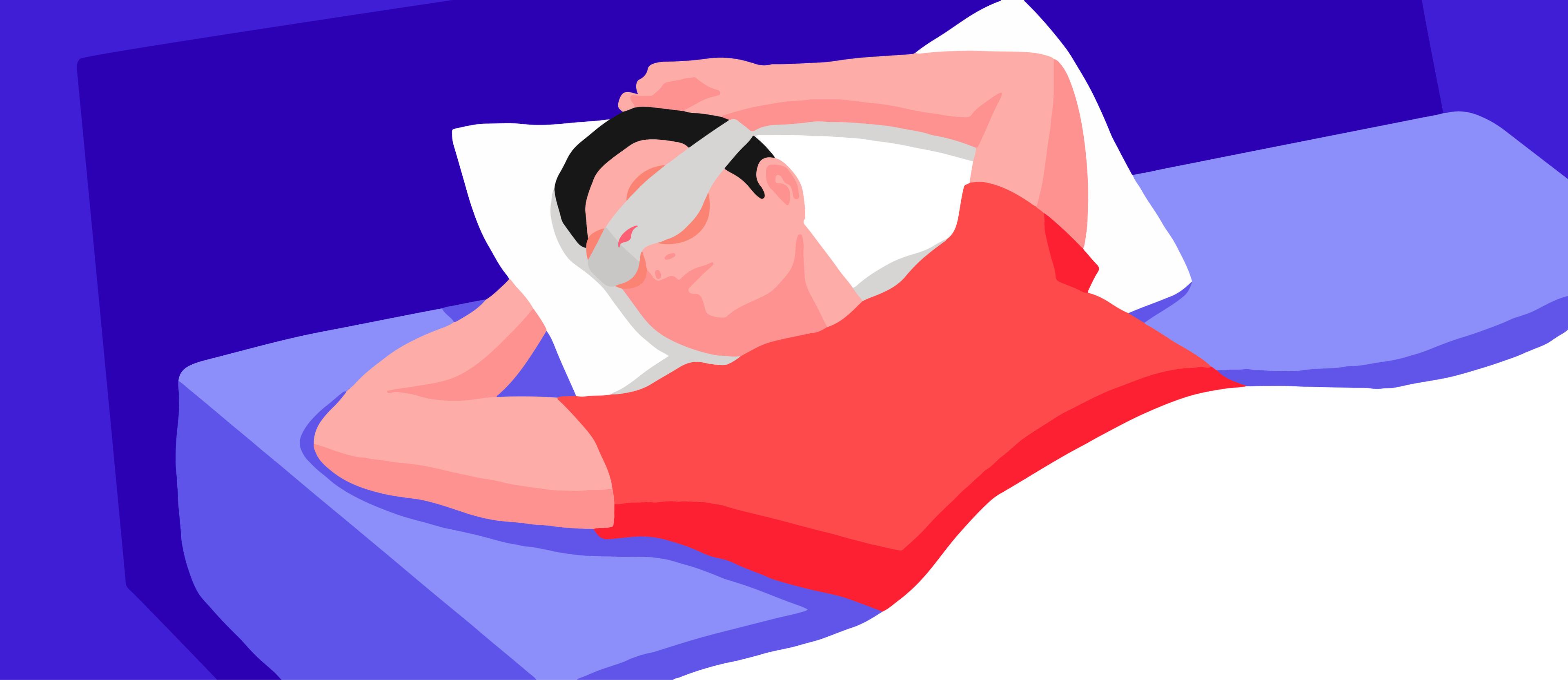 A man relaxing in bed wearing a sleep mask with heated eye cups.