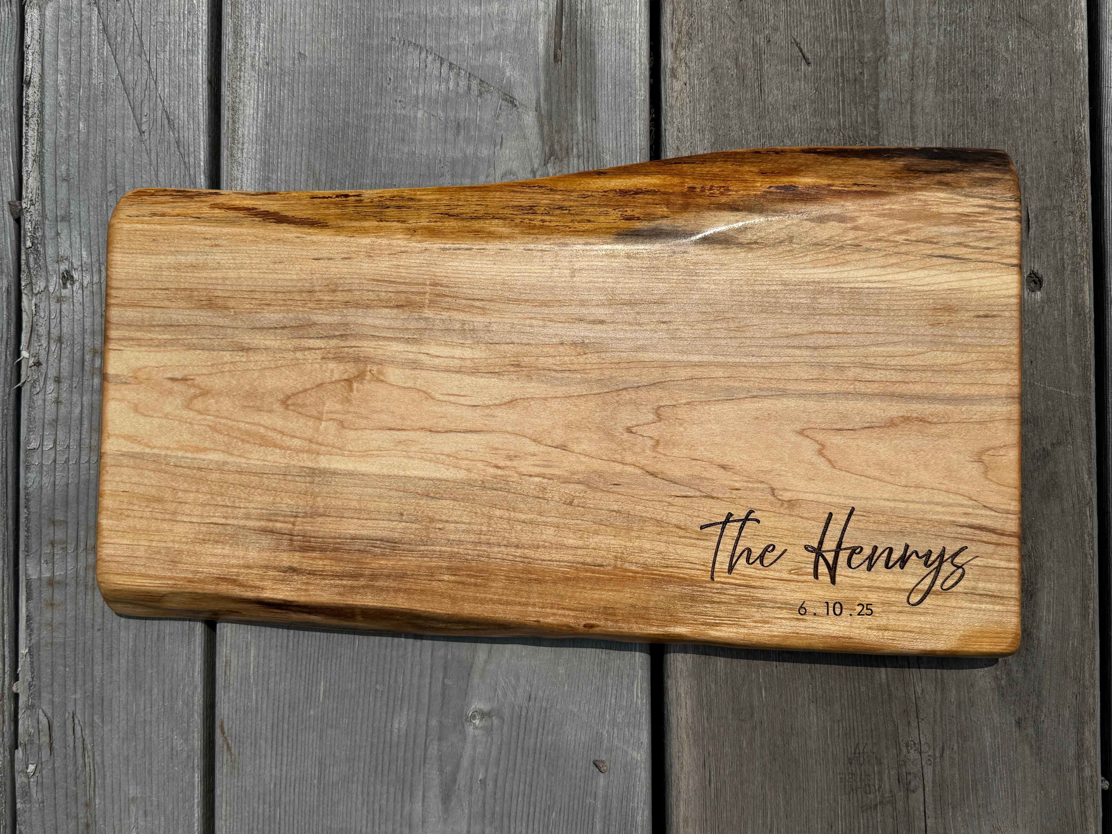 maple live edge charcuterie wedding signing board engraved with name and date.