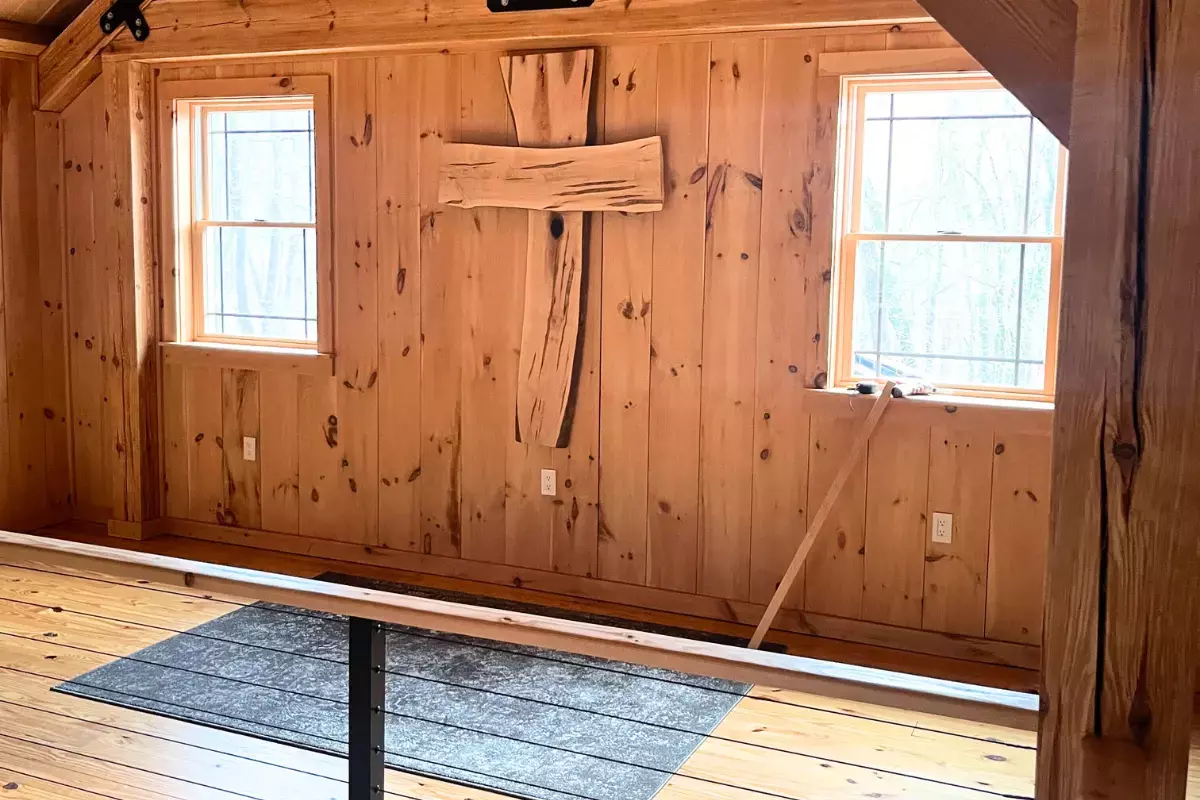 Custom wall-mounted cross crafted from live edge wormy maple