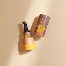 A bottle of Prinourish kept inside it's beautiful, vibrant packaging, over a beige color background with beautiful sunlight
