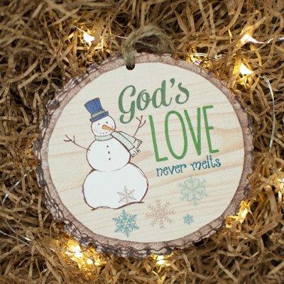 wooden circle ornament with snoman, says God's love never melts