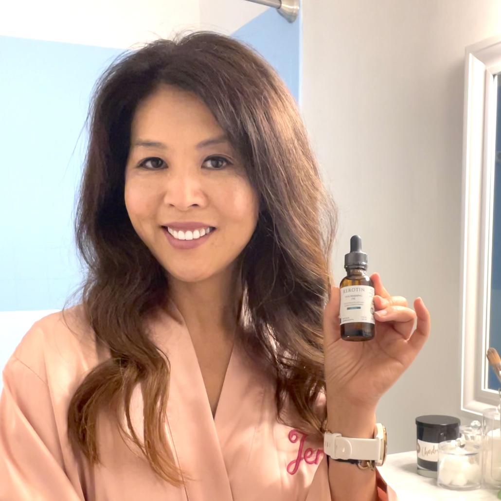 Model With Dark Hair Holding a bottle of Kerotin Hair Vitamins