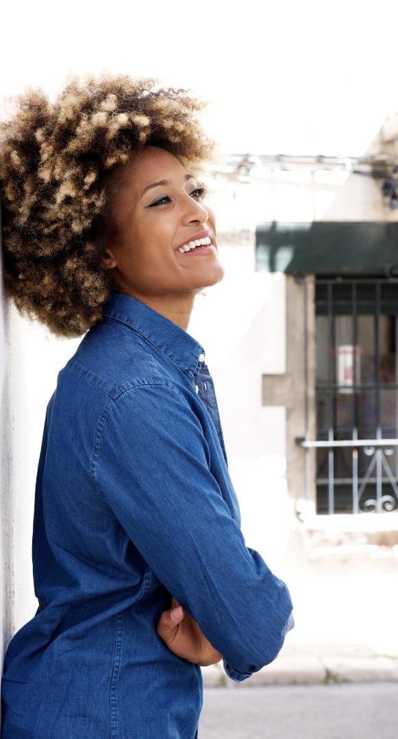Midlife Black woman with natural curls smiling confidently