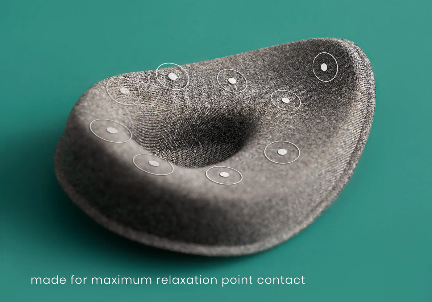 The extra tapered eye cup of a gray weighted sleep mask with beads. There is an indentation on the cup to keep direct pressure off the eyes.
