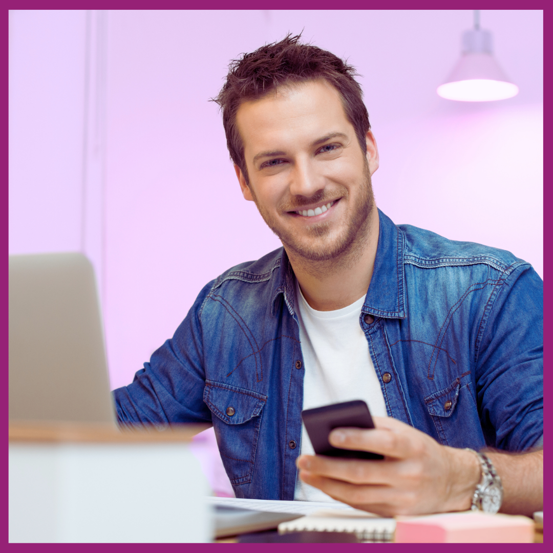 image of man looking at screen of phone
