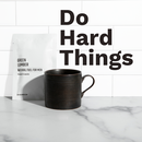 Do Hard Things. Natural Fuel package and coffee mug on counter.