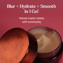 Open jar of Smooth-Sorbet face cream showing a smooth, creamy beige texture inside, against a deep pink background. Text reads: Blur + Hydrate + Smooth in 1 Go — velvet-matte meets soft luminosity.