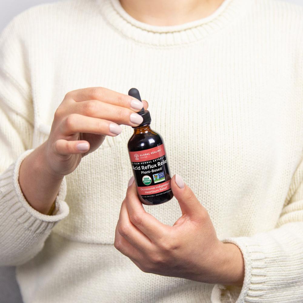 Global Healing Acid Reflux Relief Bottle In Hand