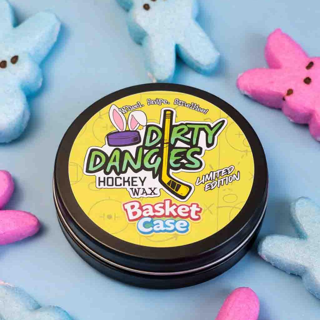 Dirty Dangles Hockey Wax Basket Case marshmallow candy scented hockey wax surrounded by colorful marshmallow Peeps on a light blue background