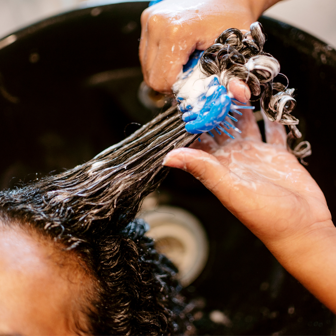 detangling hair at shampoo bowl
