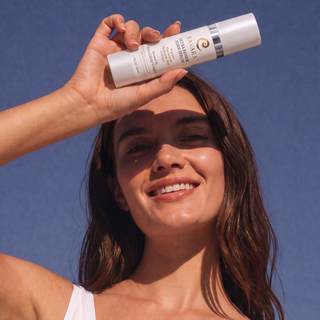 Woman holding Eavara Ultra Renew PDRN Serum bottle above her head against a blue sky