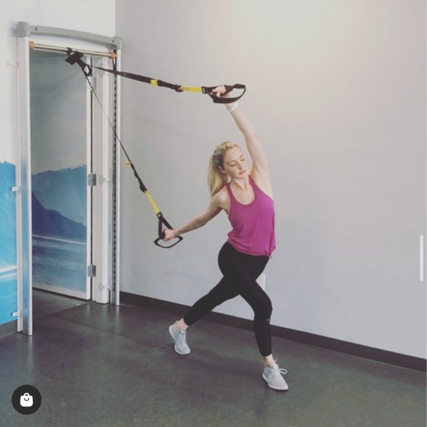 girl exercising with trx on SoloStrength doorway anchor gymhome exercise equipment by solostrength