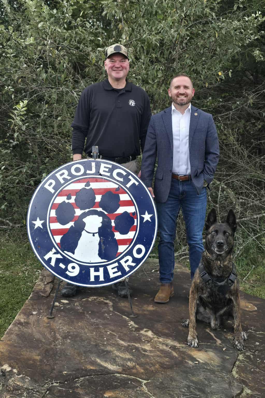zach brooks with jason johnson pose with k9 rikki