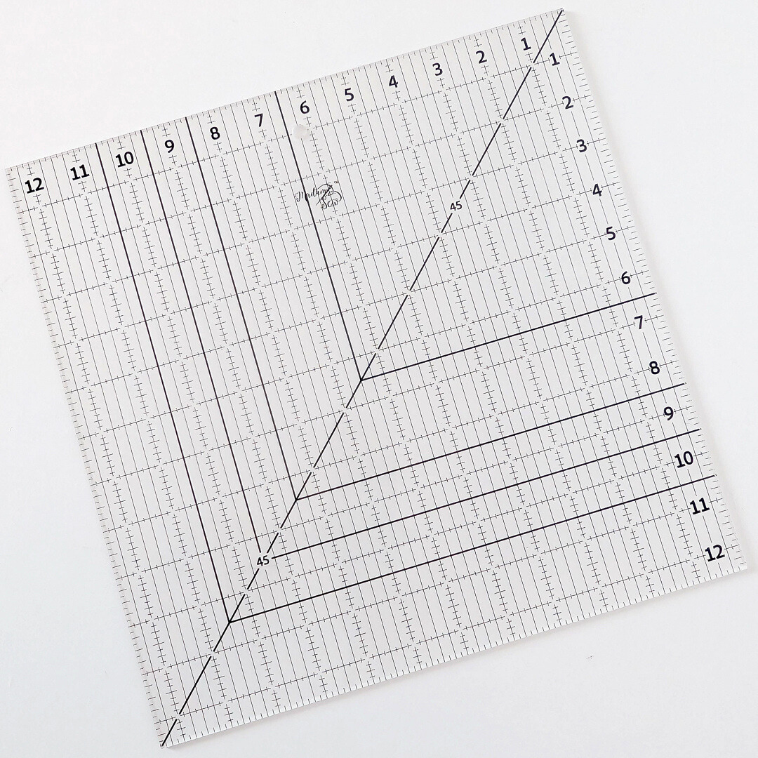 Picture of 12.5” Square-Up Quilting Ruler on white table.