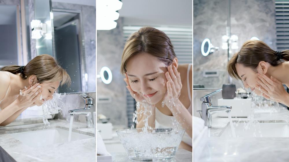 Woman washing her face at night as part of her night skincare routine.