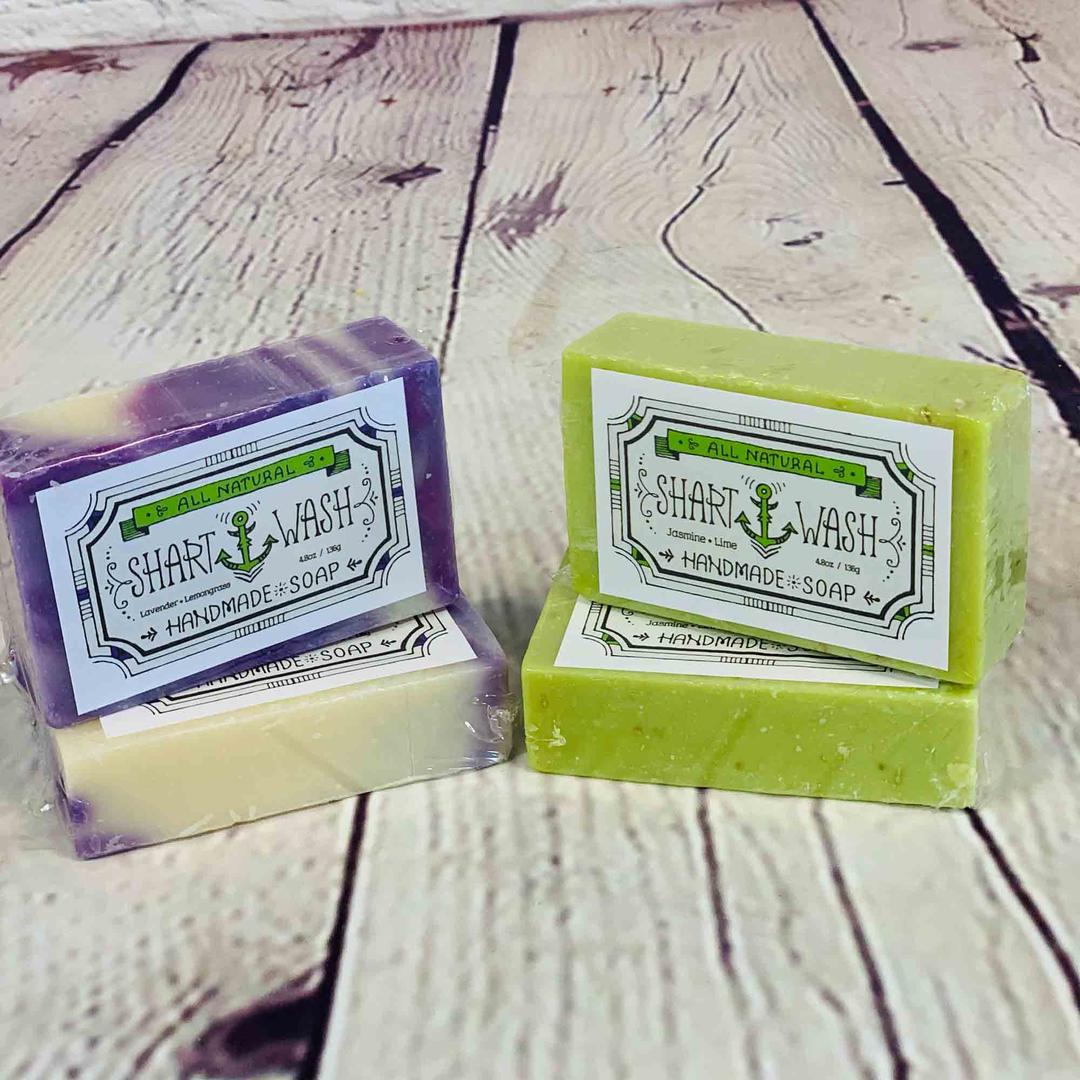 picture of purple lavender lemongrass shart wash soap and green jasmine lime soap on a wood background