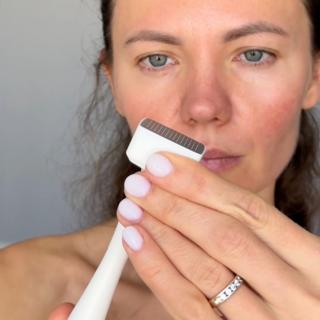 woman looking at needles on derma stamp