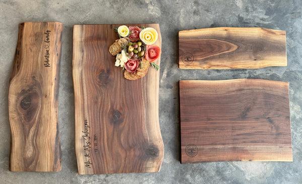 four differetn sizes of our walnut live edge charcuterie boards that have been oiled.