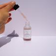 hand using a dropper from hyah serum