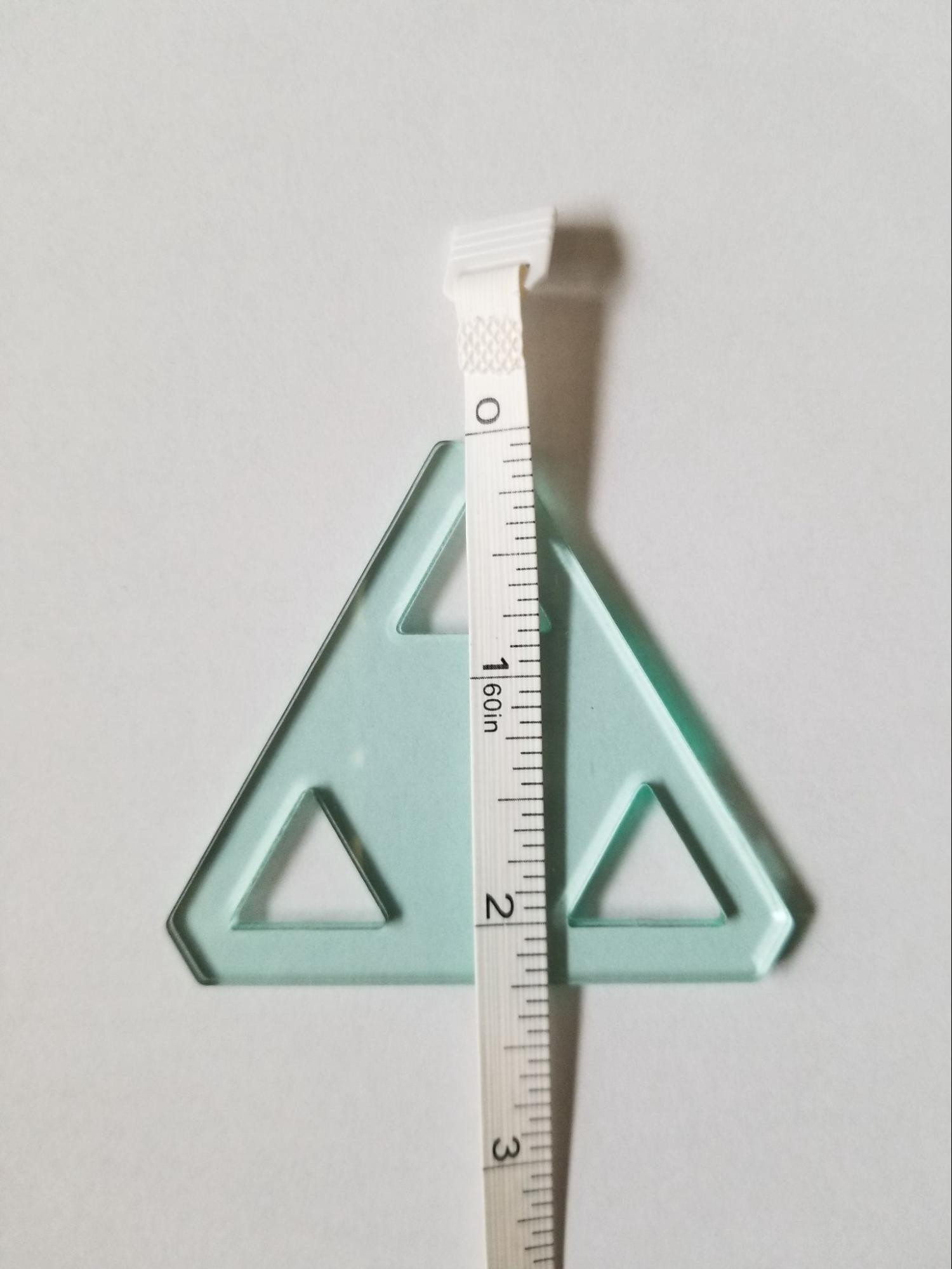 Measuring from point to base of a 60 degree triangle quilt template.