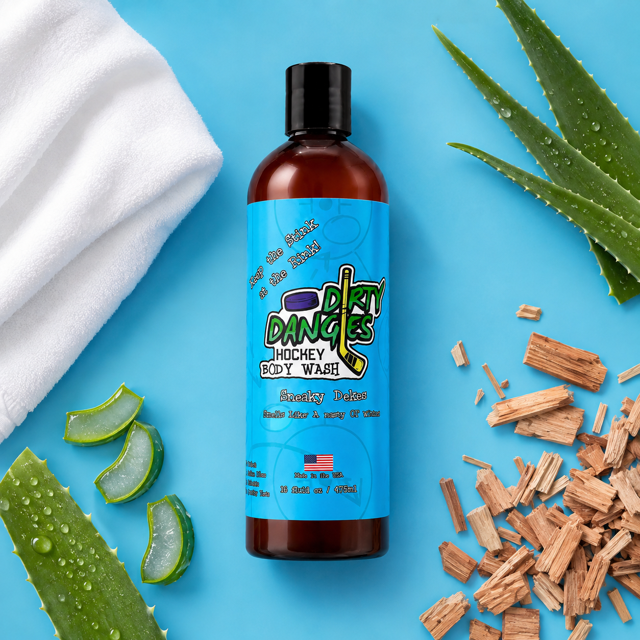 a bottle of sneaky dekes fresh linen aloe and sandalwood scented hockey body wash on a blue background with clean linen, aloe and sandalwood chunks