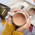 two hands holding cup of hot drinking chocolate