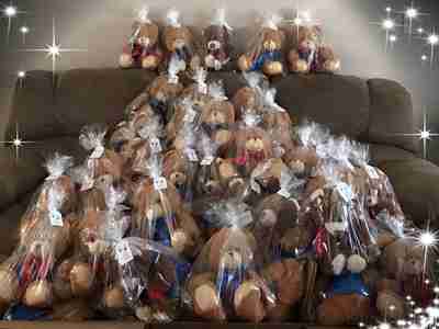 Bears inside plastic bags on top of a couch