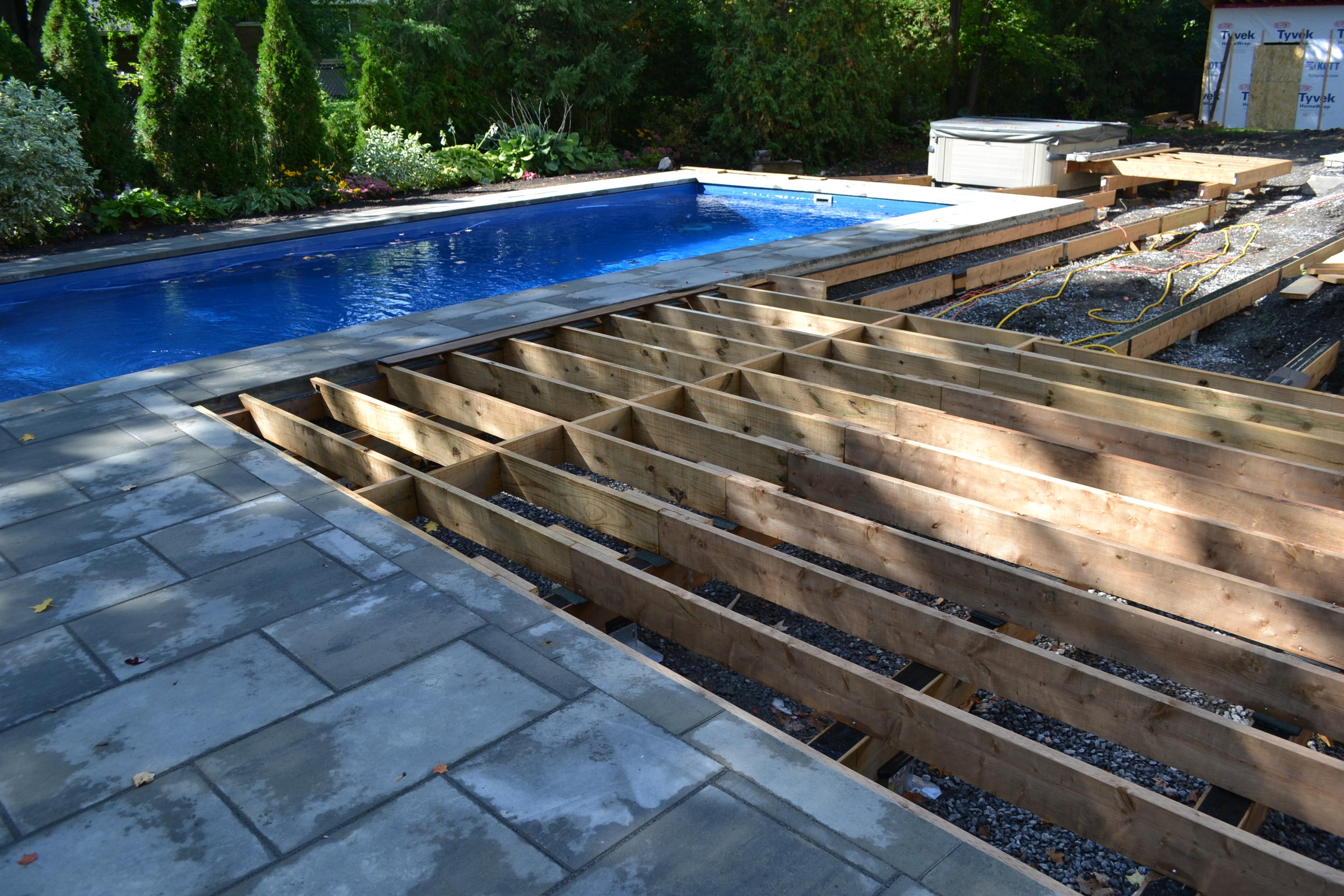 deck frame with beautiful blue pool in the background of the site
