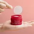 Model lifting Dim N Dazzle Spot Patch out of the jar with the tweezer provided