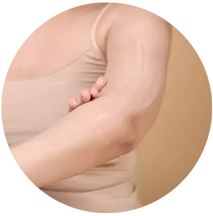 a woman dabbing on her face