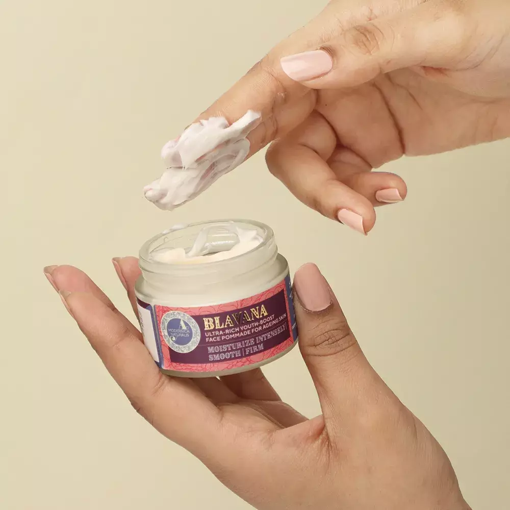 Woman taking out Blavana face pommade from the jar