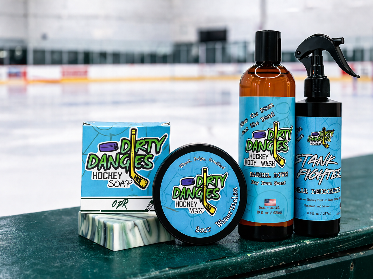 Dirty Dangles hockey soap, stick wax, body wash and gear deodorizer displayed on rink boards