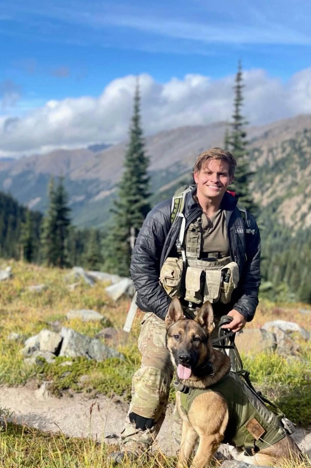mpc hektor and his handler in the mountains on a hike