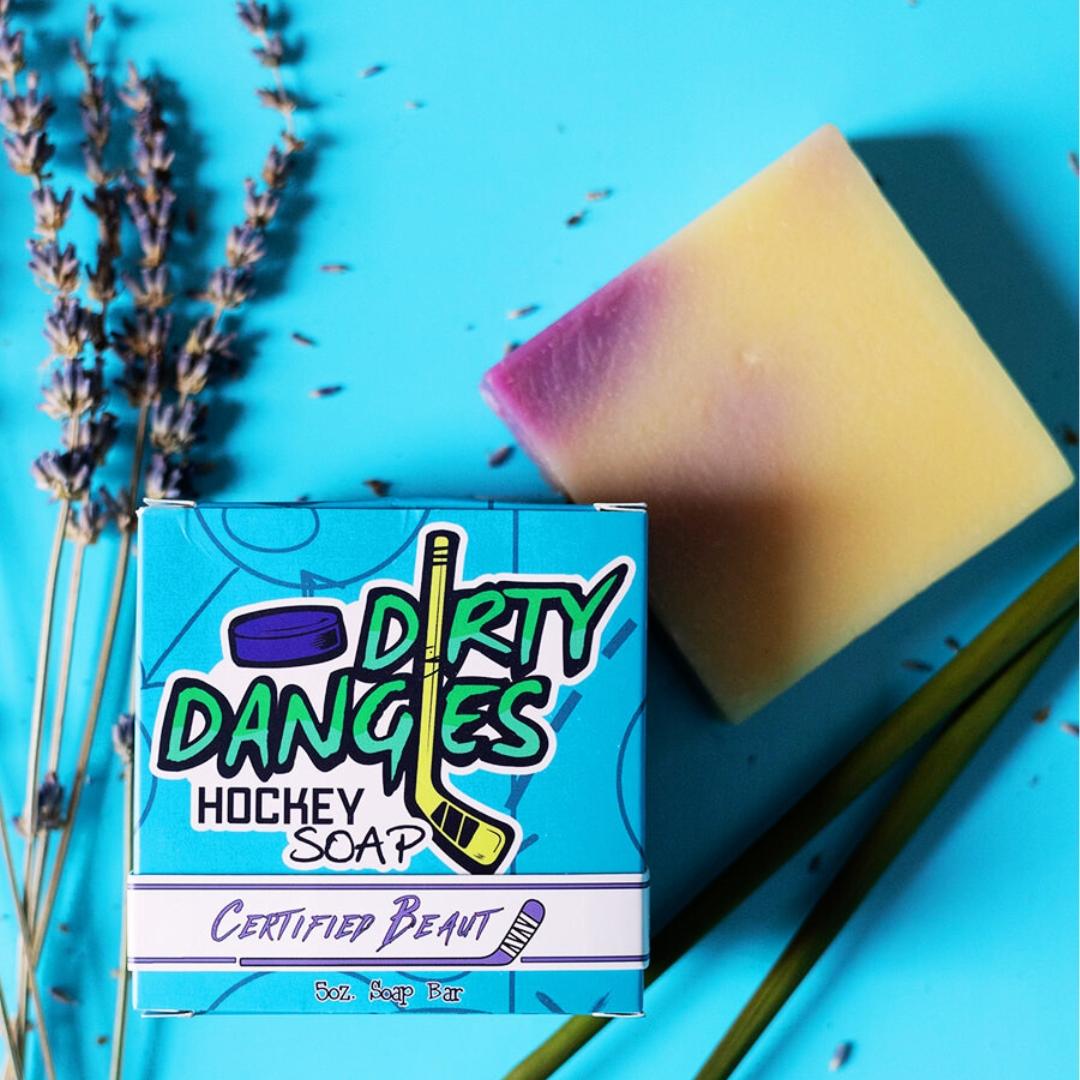 certified beaut lavender lemongrass girl's soap bar on a blue background with lavender flowers and lemongrass sticks