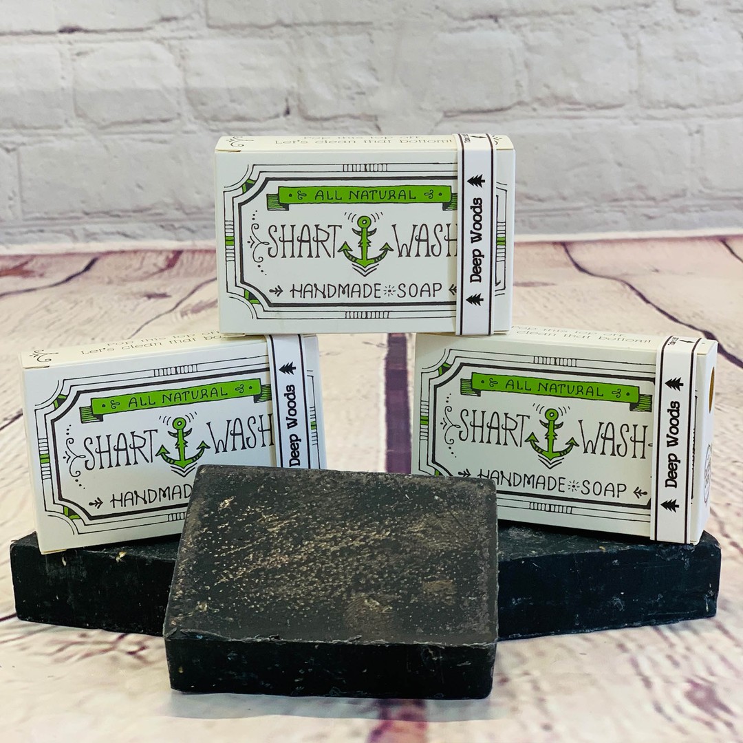 picture of 3 bars of black shart wash natural handmade soap bars on a wood background