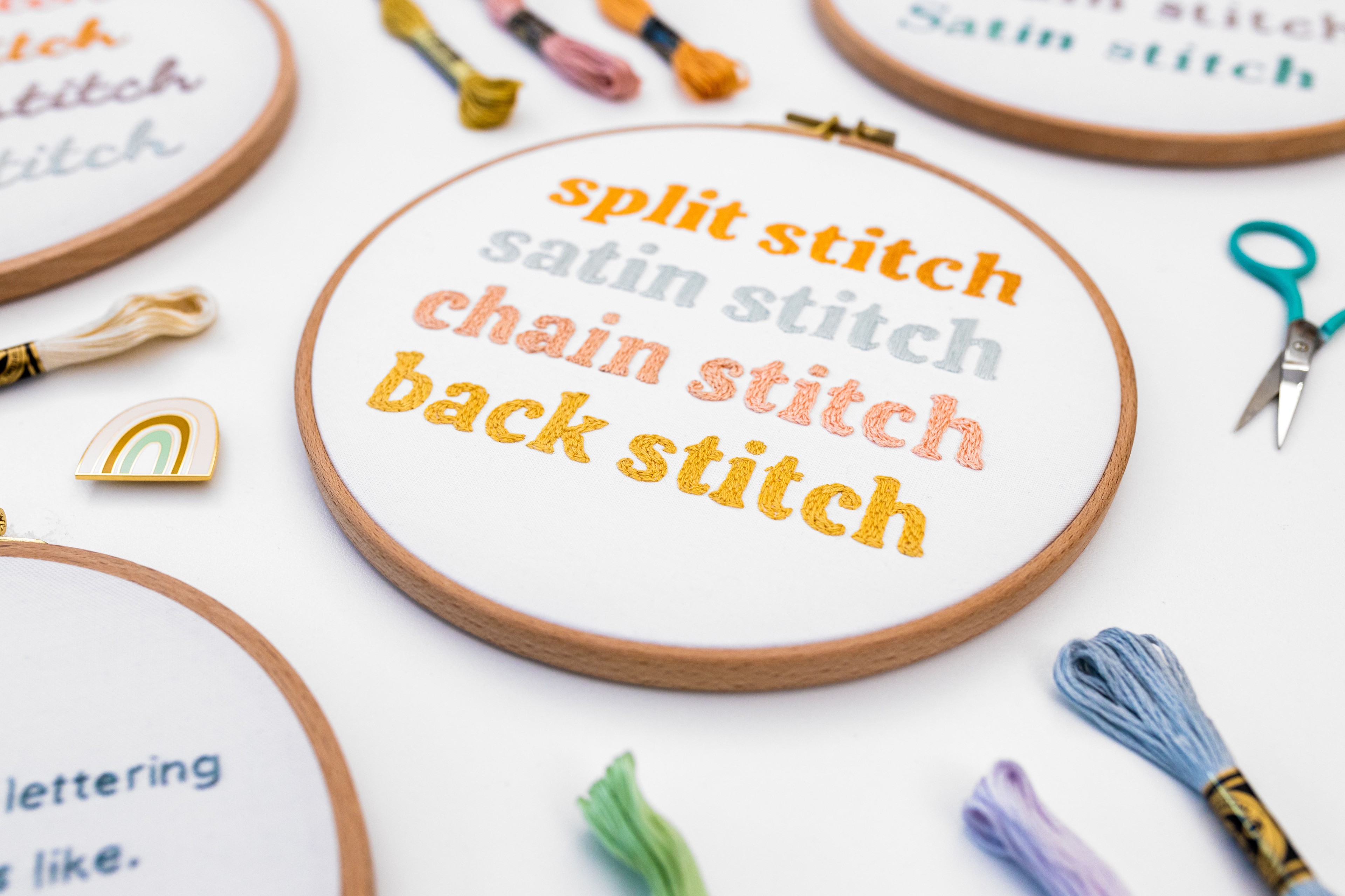 This is an image of different stitches and writing on modern embroidery hoops.