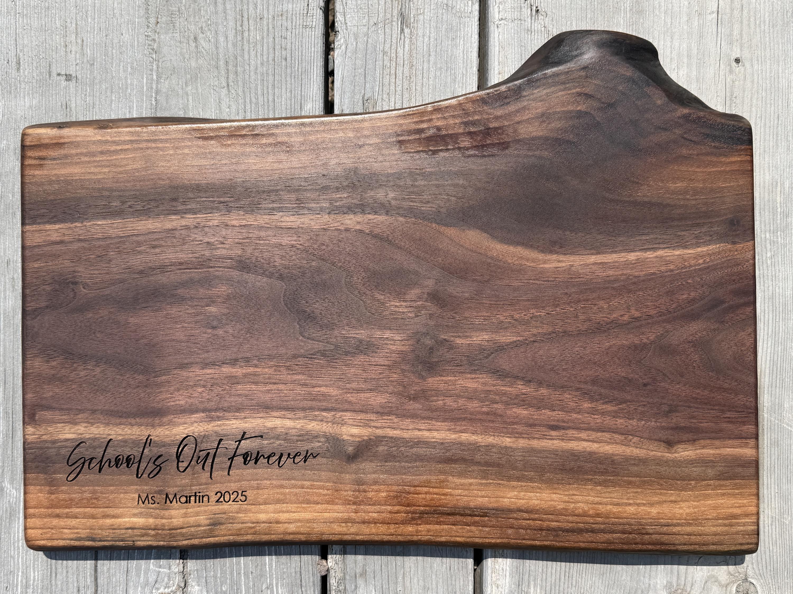 black walnut live edge charcuterie board to honor a retiring teacher with the engraving School’s out forever Ms. Martin 2025