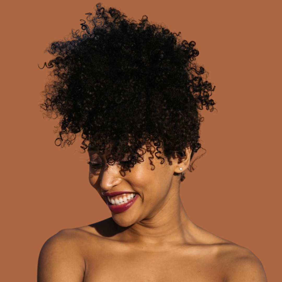 Midlife Black woman with natural curls smiling confidently