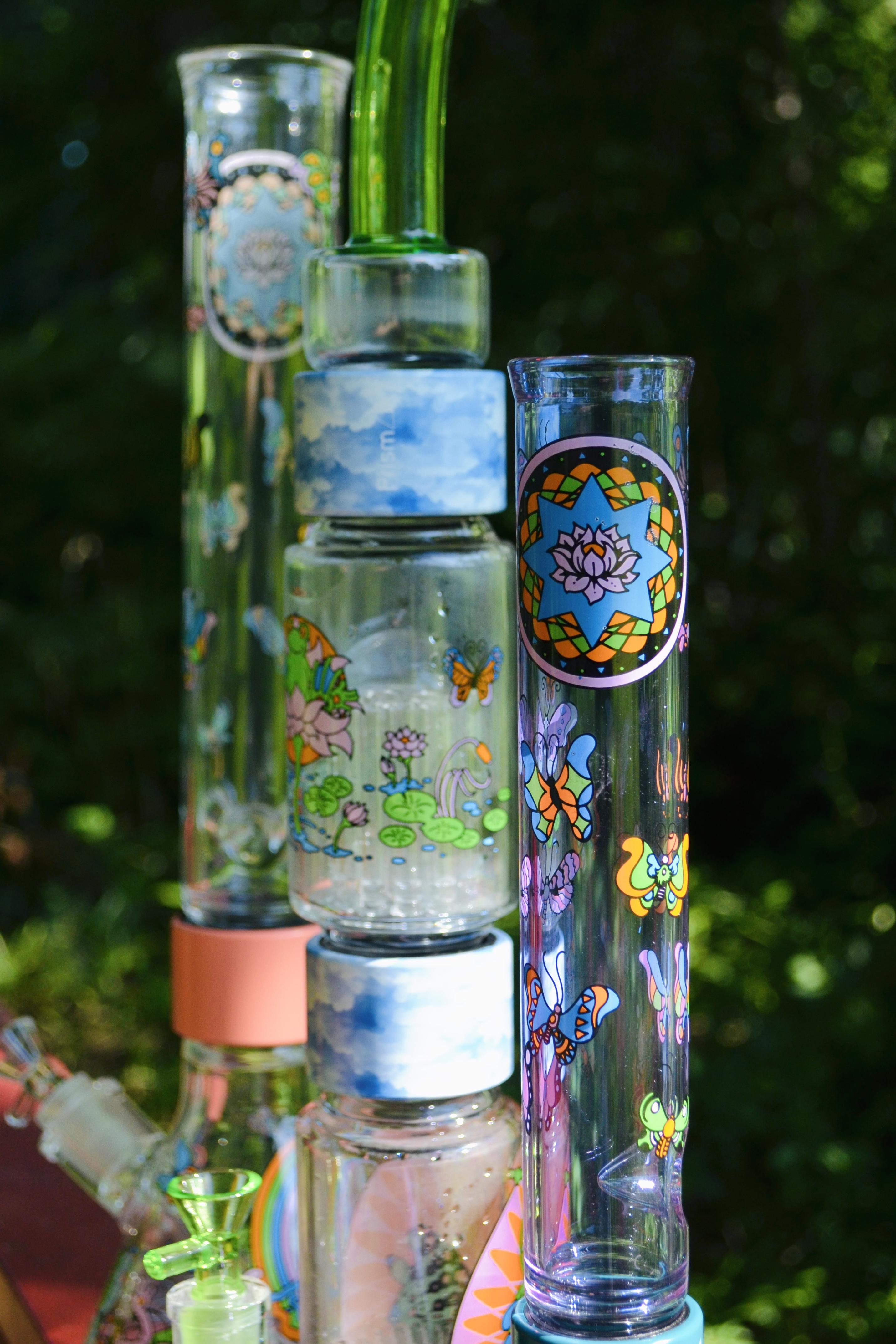 An image of three Prism bongs fully assembled outdoors with the Pond Life decal on each piece