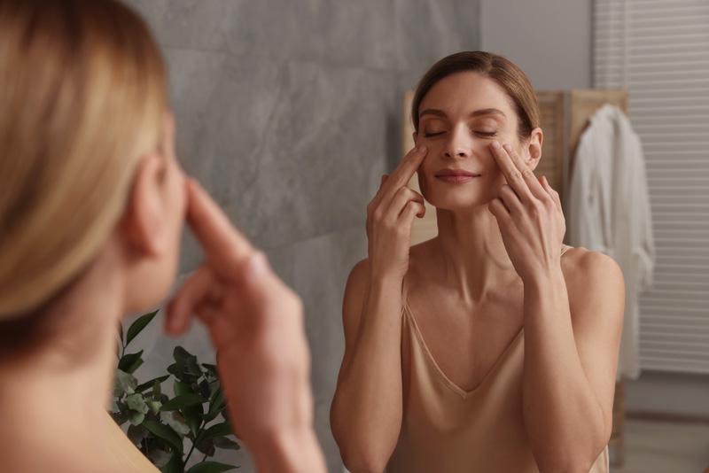 Lady doing mukhbhangya in front of her mirror