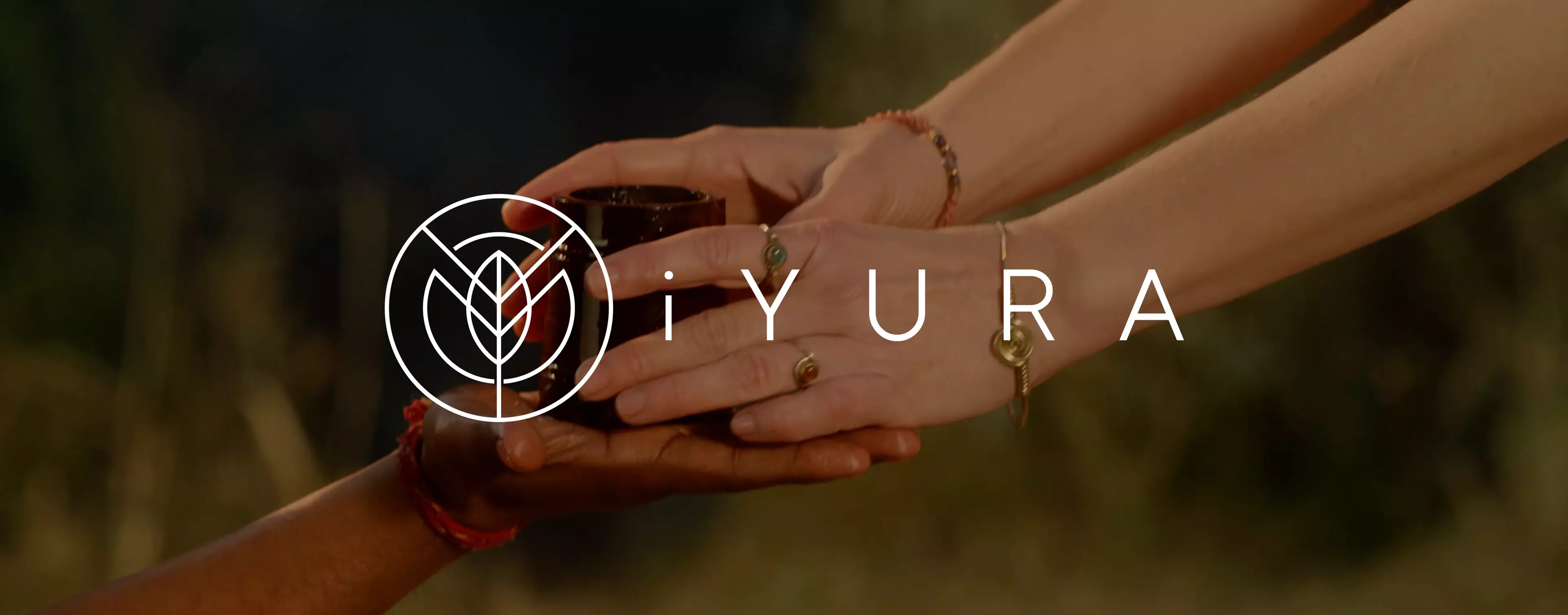 The logo of iYURA, featuring a stylized white circular emblem resembling a leaf or flower, is overlaid in the center along with the brand name “iYURA” in uppercase white letters.