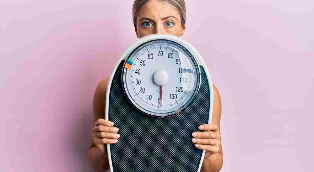 woman holding weight scale