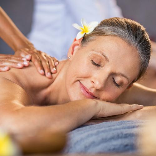 senior woman relaxing as she gets a massage.
