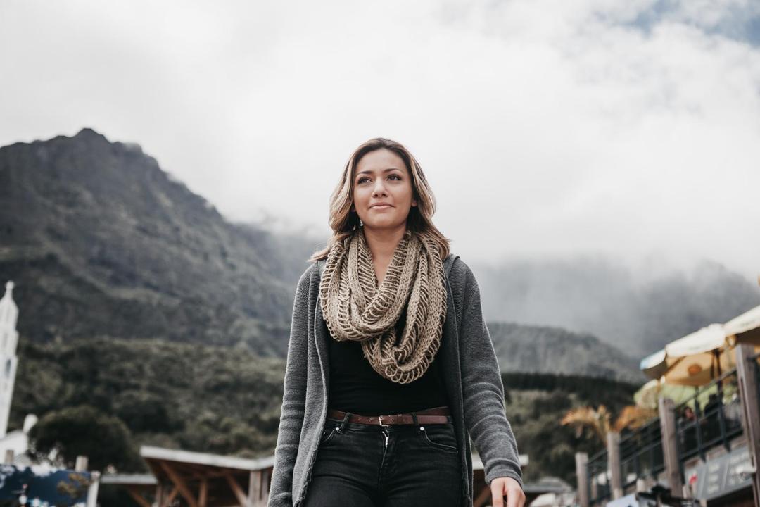 Woman walking with mountains in the background