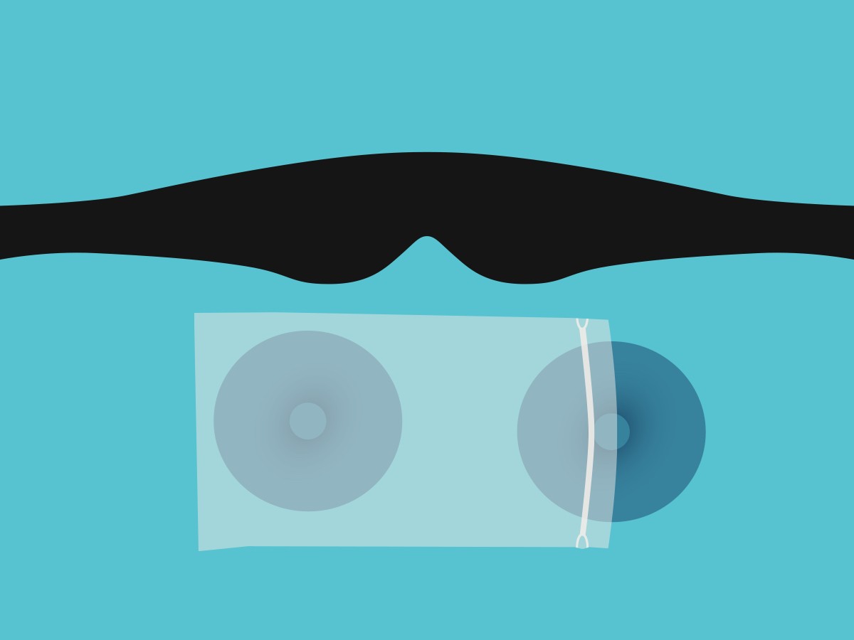 A black head strap of a cooling eye mask lying flat and a pair of blue cooling eye cups inside a freezer-safe bag.