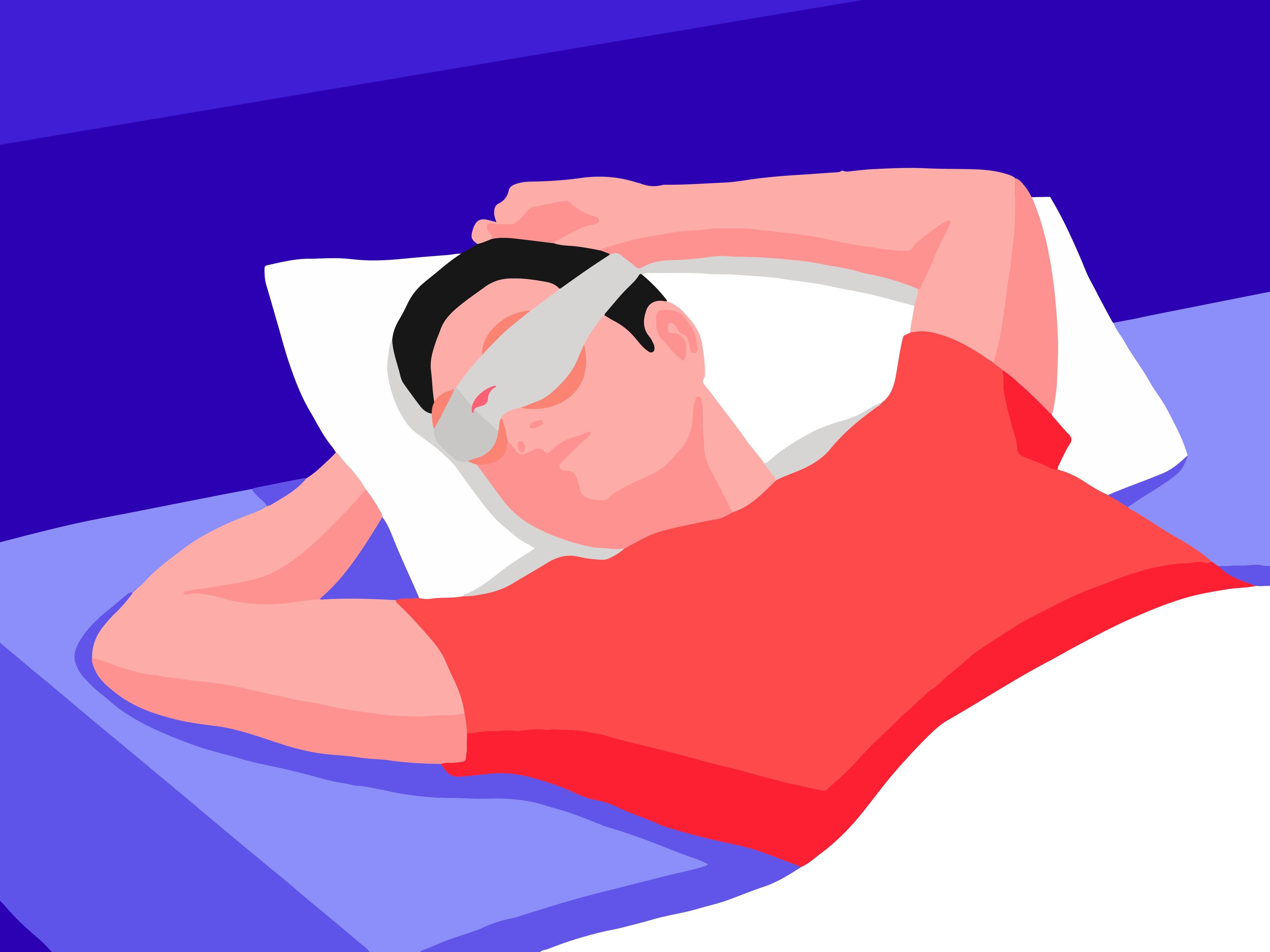 A man relaxing in bed wearing a sleep mask with heated eye cups.