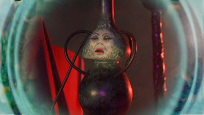 Close-up of the demonic character Eebee, the possessed antique water pipe from the stoner horror movie Evil Bong, emphasizing the blog's warning: Choose quality gear like a Prism Water Pipe over sketchy, novelty glass.