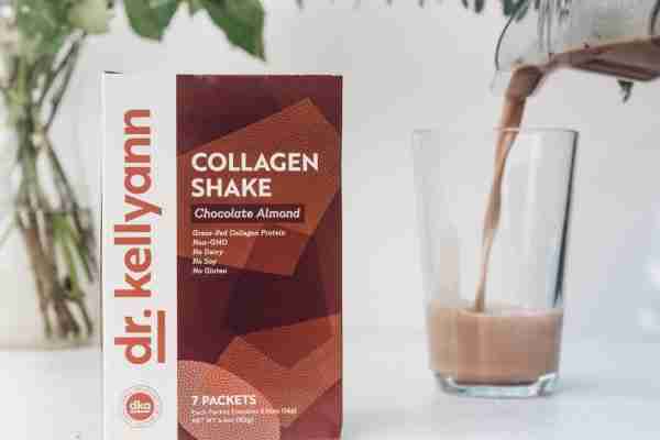 Dr. Kellyann chocolate almond collagen shake being poured into glass