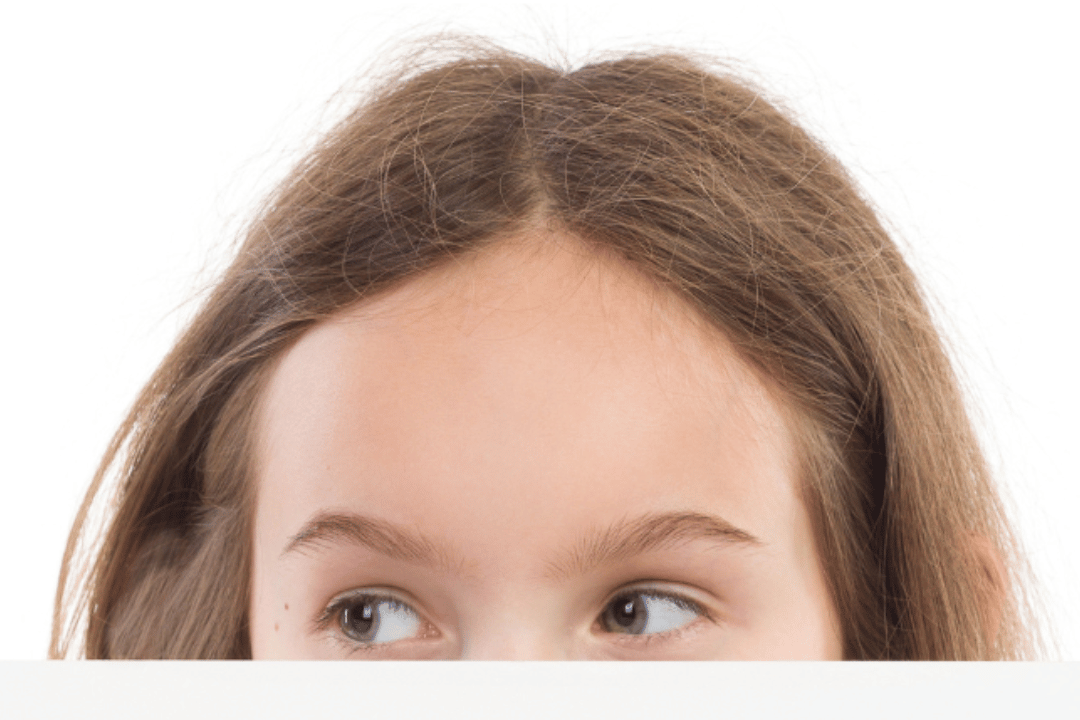girl peeking over short wall