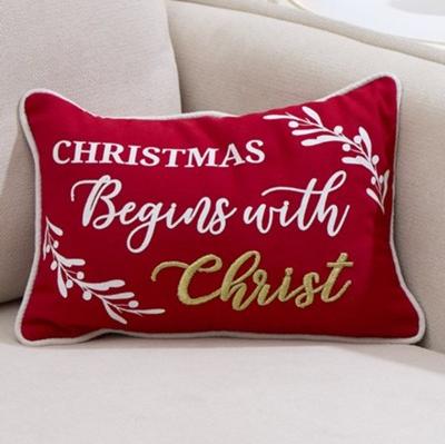 Small red pillow that says Christmas Begins with Christ